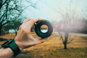 Camera lens symbolising focus and clarity, with the phrase 'How to Stay Focused On Your Goals'